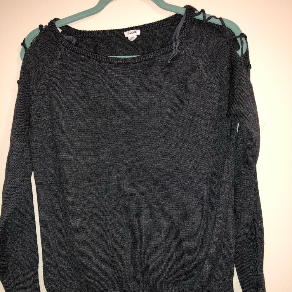 Grey knitted sweater with crossed fabric on sleeve